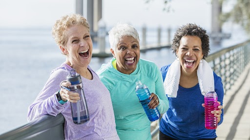 senior women outside on a walk with water bottles