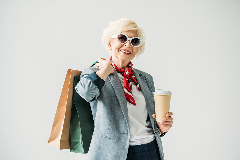 Woman holding shopping bags and coffee
