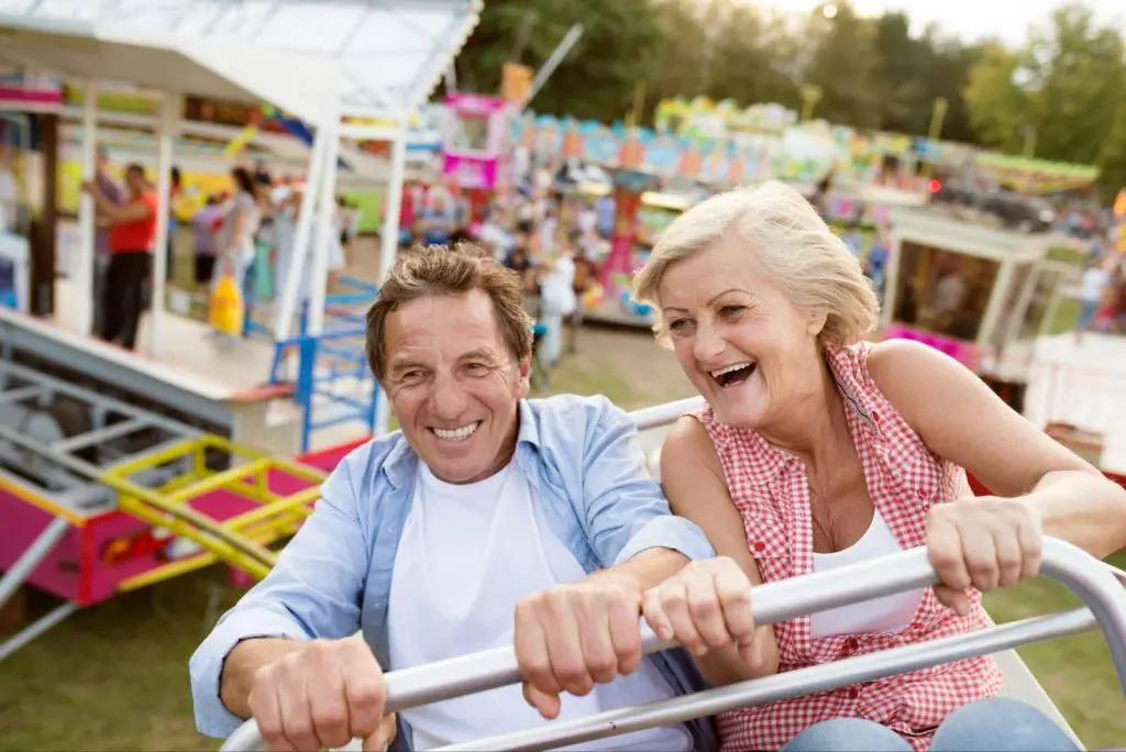 Senior couple enjoying a fair ride