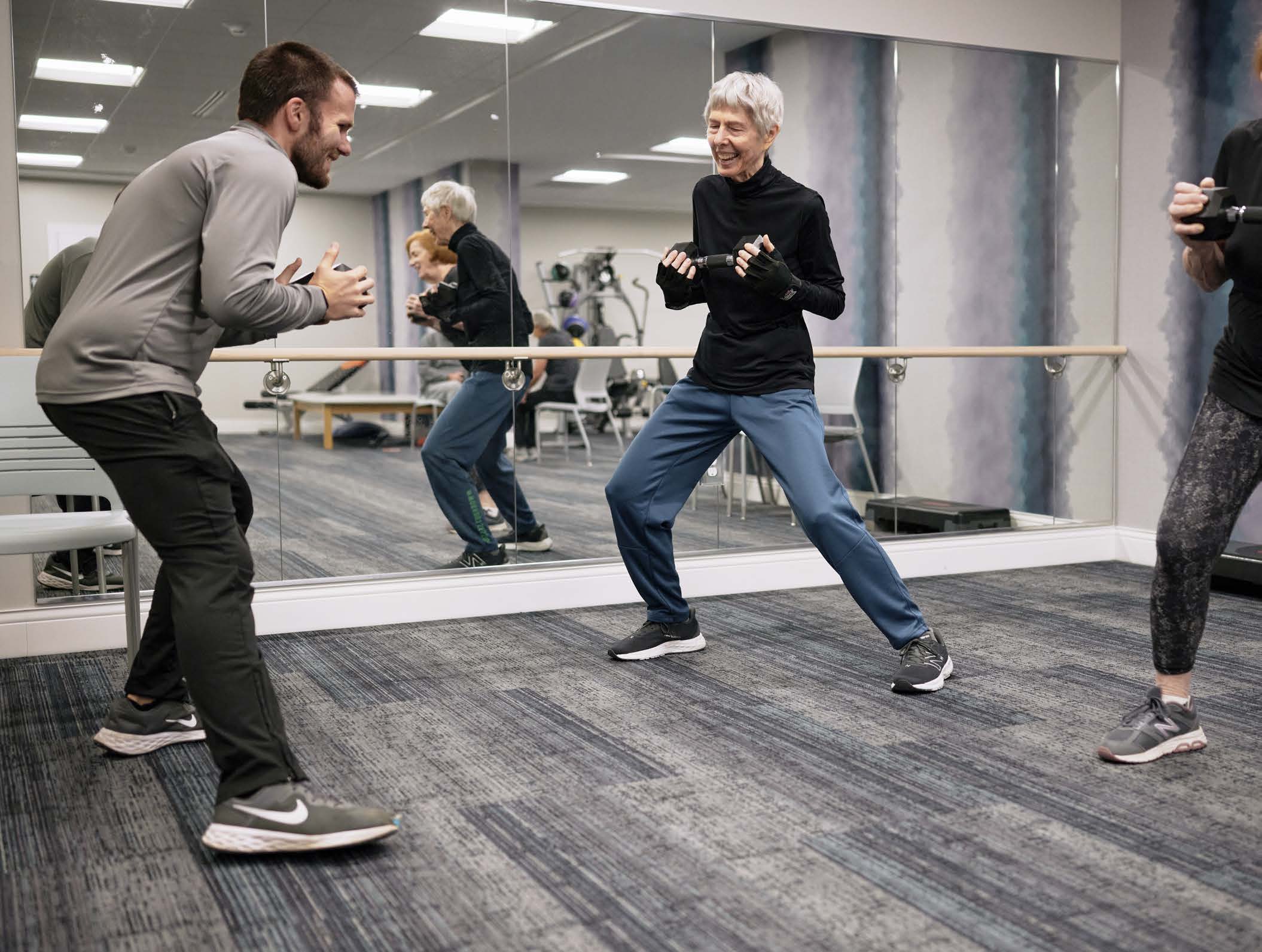 Senior and trainer exercising