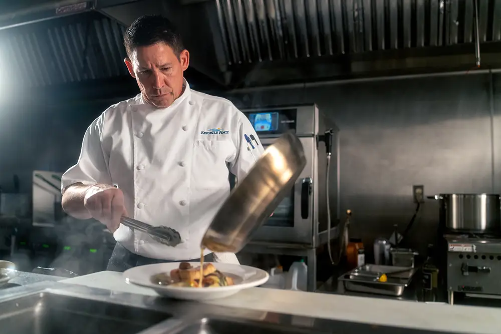 Chef preparing a meal at Eastcastle Place