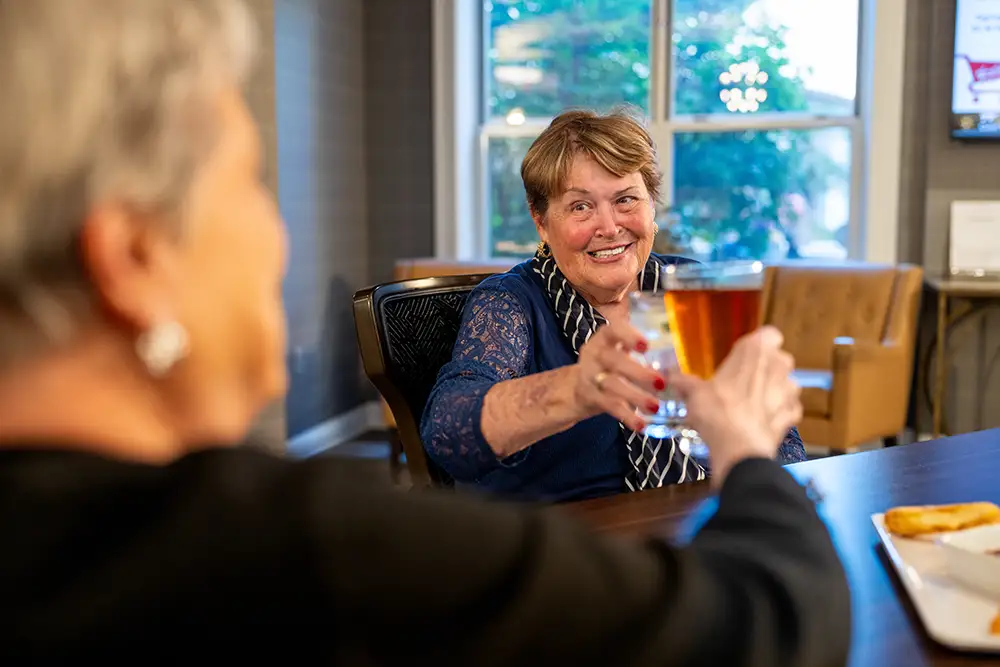 Resident proposing a toast at Eastcastle Place