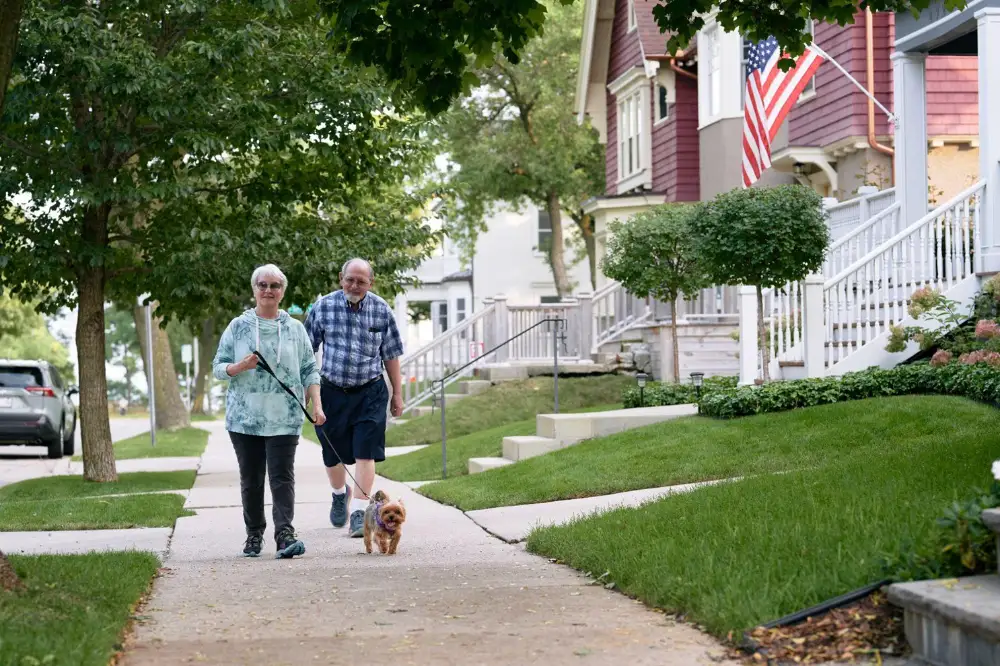 a senior couple walking their dog