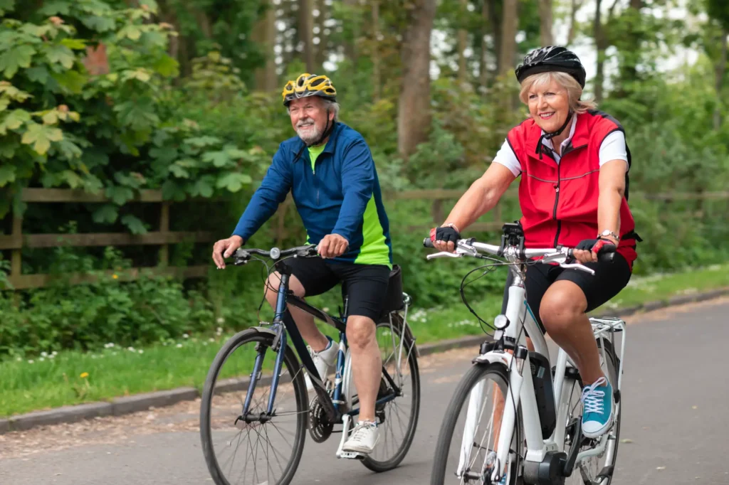 2 elder adults exploring cycling for seniors in Milwaukee, WI, on a trail near Eastcastle Place