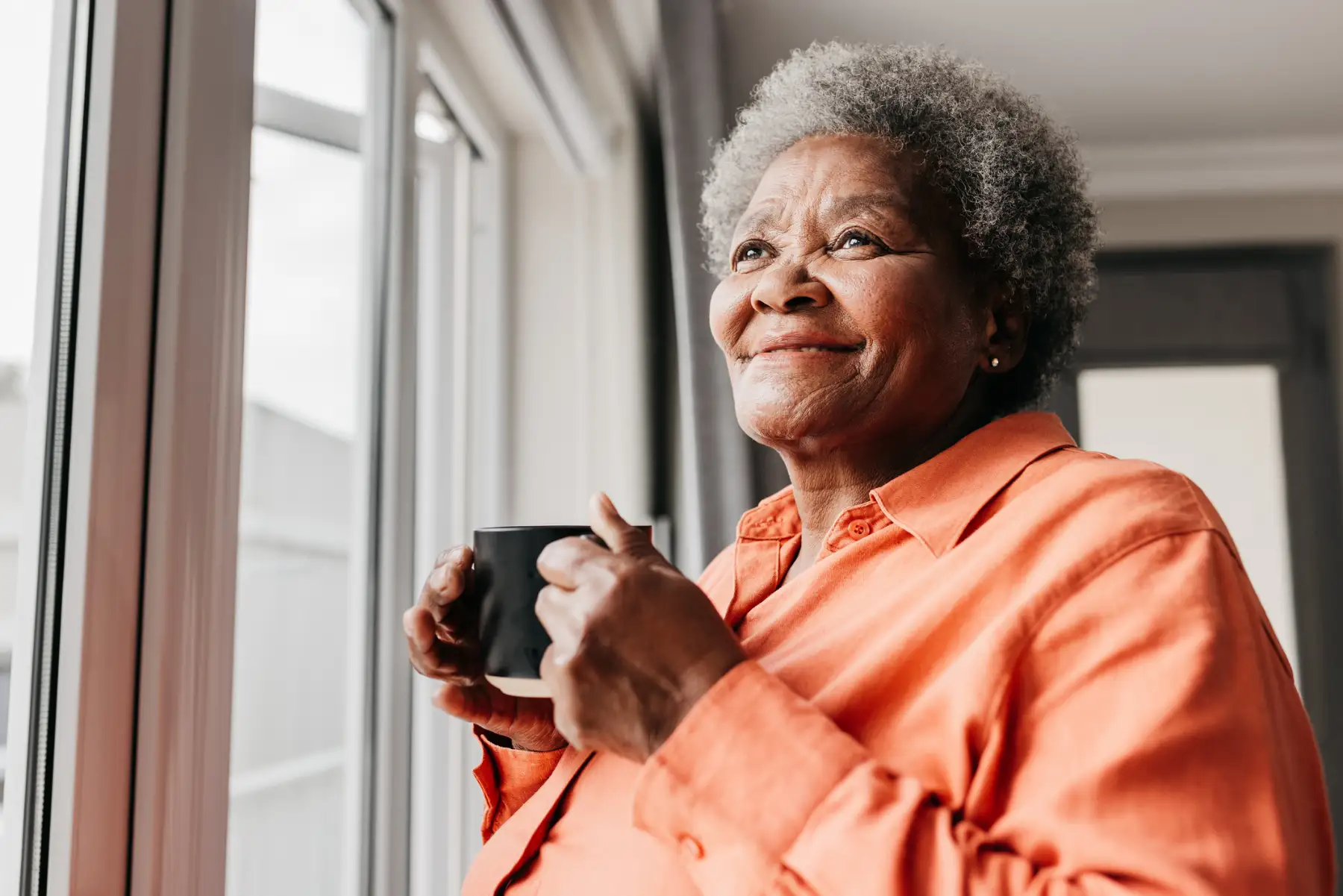 a senior woman enjoying a cup of coffee